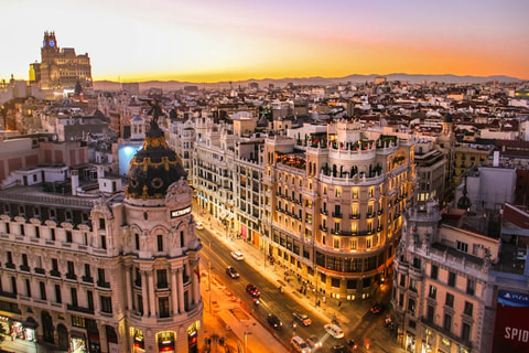 Grand buildings along Gran Vía in Madrid at sunset